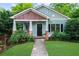 Charming craftsman home boasts a tidy front lawn, quaint porch, and stylish architectural details at 2324 Oakview Ne Rd, Atlanta, GA 30317