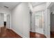 Hallway with white walls and wood floors leading to a bathroom and other rooms of the house at 2324 Oakview Ne Rd, Atlanta, GA 30317