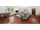 Spacious living room featuring hardwood floors, large windows, and stylish contemporary furniture at 2324 Oakview Ne Rd, Atlanta, GA 30317