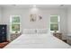 Bright main bedroom boasts hardwood floors, two windows, and neutral decor at 2324 Oakview Ne Rd, Atlanta, GA 30317