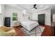 Spacious main bedroom with modern ceiling fan, wood floors, tray ceiling, two windows, and neutral decor at 2324 Oakview Ne Rd, Atlanta, GA 30317