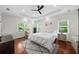 Charming main bedroom boasts hardwood floors, tray ceiling, ceiling fan, and serene window views at 2324 Oakview Ne Rd, Atlanta, GA 30317