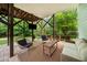 Comfortable covered patio featuring wicker furniture, a coffee table, and an entertainment area with a TV at 2324 Oakview Ne Rd, Atlanta, GA 30317