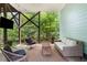 Relaxing covered patio with wicker furniture and a mounted TV, perfect for outdoor entertainment at 2324 Oakview Ne Rd, Atlanta, GA 30317