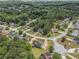 Aerial view of a neighborhood showcasing mature trees and well-maintained lawns at 2451 Broad River Pl, Ellenwood, GA 30294