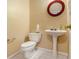 Half bathroom featuring a pedestal sink, toilet, and a decorative mirror at 2451 Broad River Pl, Ellenwood, GA 30294