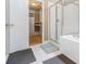 Bright bathroom featuring a glass shower, separate tub, and access to a walk-in closet at 2451 Broad River Pl, Ellenwood, GA 30294