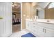 Bright bathroom with a white vanity, mirror, and a glimpse of the bedroom at 2451 Broad River Pl, Ellenwood, GA 30294