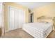 Comfortable bedroom with soft carpet, decorative headboard, and a double door closet at 2451 Broad River Pl, Ellenwood, GA 30294