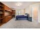 Comfortable bedroom with a bed, built-in shelves, and a desk at 2451 Broad River Pl, Ellenwood, GA 30294