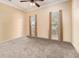 Light-filled bedroom with carpet and two large windows at 2451 Broad River Pl, Ellenwood, GA 30294