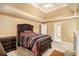 Bedroom with trey ceilings, carpeted floors, large bed, and adjoining bathroom and closet at 2451 Broad River Pl, Ellenwood, GA 30294
