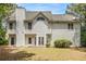 Two-story home's back exterior features siding, windows, lawn, patio, and mature trees at 2451 Broad River Pl, Ellenwood, GA 30294