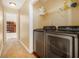 Functional laundry room with side-by-side washer and dryer at 2451 Broad River Pl, Ellenwood, GA 30294