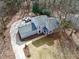 Aerial view of a well maintained house with vehicles in the driveway, surrounded by trees in a quiet neighborhood at 5419 S Lake Dr, Douglasville, GA 30135