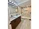 Bathroom with a modern double sink vanity and a glass-enclosed shower with decorative marble-like tile at 5419 S Lake Dr, Douglasville, GA 30135