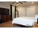 Bedroom featuring a white bed, wooden floors, a large television, and ample closet space at 5419 S Lake Dr, Douglasville, GA 30135