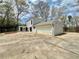 Home exterior featuring a spacious driveway, large garage, and well-maintained yard with mature trees at 5419 S Lake Dr, Douglasville, GA 30135