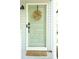 Inviting mint green front door adorned with a decorative wreath, set against light gray siding and a woven doormat at 5419 S Lake Dr, Douglasville, GA 30135