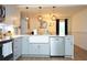 Modern kitchen with stainless steel appliances, white cabinets, and a farmhouse sink at 5419 S Lake Dr, Douglasville, GA 30135