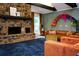 Cozy living room with a stone fireplace, plush seating, and a vibrant accent wall at 5419 S Lake Dr, Douglasville, GA 30135