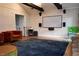 A living room is staged with a blank movie screen, two orange chairs, and a geometric patterned rug at 5419 S Lake Dr, Douglasville, GA 30135