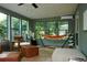 Bright sunroom featuring plenty of windows, comfortable seating, and natural light at 5419 S Lake Dr, Douglasville, GA 30135