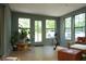 Sunroom with several windows offering views of the outdoors and comfortable seating at 5419 S Lake Dr, Douglasville, GA 30135