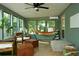 Bright and airy sunroom with a hammock, large windows, and comfortable seating at 5419 S Lake Dr, Douglasville, GA 30135