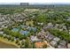 Aerial view highlighting community with UFA soccer fields, tennis courts, pool, lake, and houses with tree coverage at 6815 Berkley Rd, Cumming, GA 30040