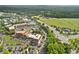 Scenic aerial view of a town center with commercial buildings, roads, and surrounding green landscape at 6815 Berkley Rd, Cumming, GA 30040