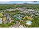 An aerial view showcasing the community amenities, including a lake, tennis courts, and a swimming pool at 6815 Berkley Rd, Cumming, GA 30040