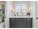 Bathroom with a dark vanity with marble countertop and framed window over the sink at 6815 Berkley Rd, Cumming, GA 30040