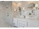 Modern bathroom featuring double vanity with marble countertop and tiled glass shower at 6815 Berkley Rd, Cumming, GA 30040