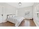 Bedroom with hardwood floor and a made bed with a window at 6815 Berkley Rd, Cumming, GA 30040