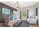 Bedroom with a comfortable armchair, sports jersey art and plenty of natural light at 6815 Berkley Rd, Cumming, GA 30040