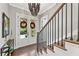 Elegant foyer showcasing a staircase with iron railings and a view of the front door with seasonal wreaths at 6815 Berkley Rd, Cumming, GA 30040