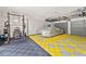Spacious garage featuring ample storage, weight training equipment and space for a car at 6815 Berkley Rd, Cumming, GA 30040