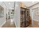 Hallway with wine storage, hardwood floors, and elegant lighting at 6815 Berkley Rd, Cumming, GA 30040