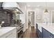 Gourmet kitchen featuring stainless steel appliances, a white marble island, and a black subway tile backsplash at 6815 Berkley Rd, Cumming, GA 30040