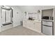 Living area with a built in storage and shelving, small refrigerator, microwave and beverage center at 6815 Berkley Rd, Cumming, GA 30040