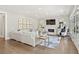 Cozy living room with fireplace, white sofa, designer rug, and abundant natural light at 6815 Berkley Rd, Cumming, GA 30040