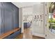 Mud room with built-in storage and bench, offering a glimpse into the kitchen at 6815 Berkley Rd, Cumming, GA 30040