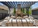 Stone fireplace with outdoor seating area and a black pergola structure at 6815 Berkley Rd, Cumming, GA 30040