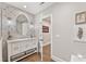 Stylish powder room with patterned accent wall, marble countertop, and decorative mirror at 6815 Berkley Rd, Cumming, GA 30040