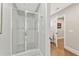 Modern shower with glass door, tiled walls, and updated fixtures at 6815 Berkley Rd, Cumming, GA 30040