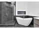 Modern bathroom featuring glass shower, soaking tub, and sleek design at 2207 Concordia Se Way # 12, Mableton, GA 30126