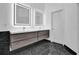Modern bathroom with dual floating vanity, LED mirrors, sleek fixtures, and black marble flooring at 2207 Concordia Se Way # 12, Mableton, GA 30126