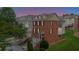 Beautiful brick townhouse with a well-manicured lawn and a quaint front entrance with black shutters and a backdrop of trees at 2207 Concordia Se Way # 12, Mableton, GA 30126
