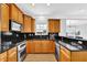 Beautiful kitchen boasts wood cabinets, black countertops, and stainless steel appliances at 2207 Concordia Se Way # 12, Mableton, GA 30126